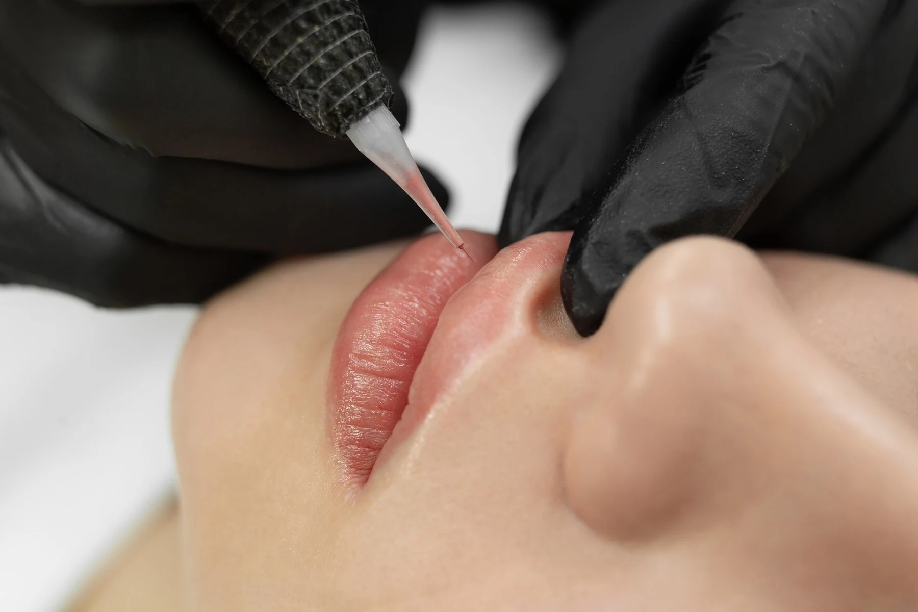 Procedimiento de micropigmentación de labios, en primer plano, en un tratamiento de Micropigmentación y microblading de Clínica Malai en Bilbao